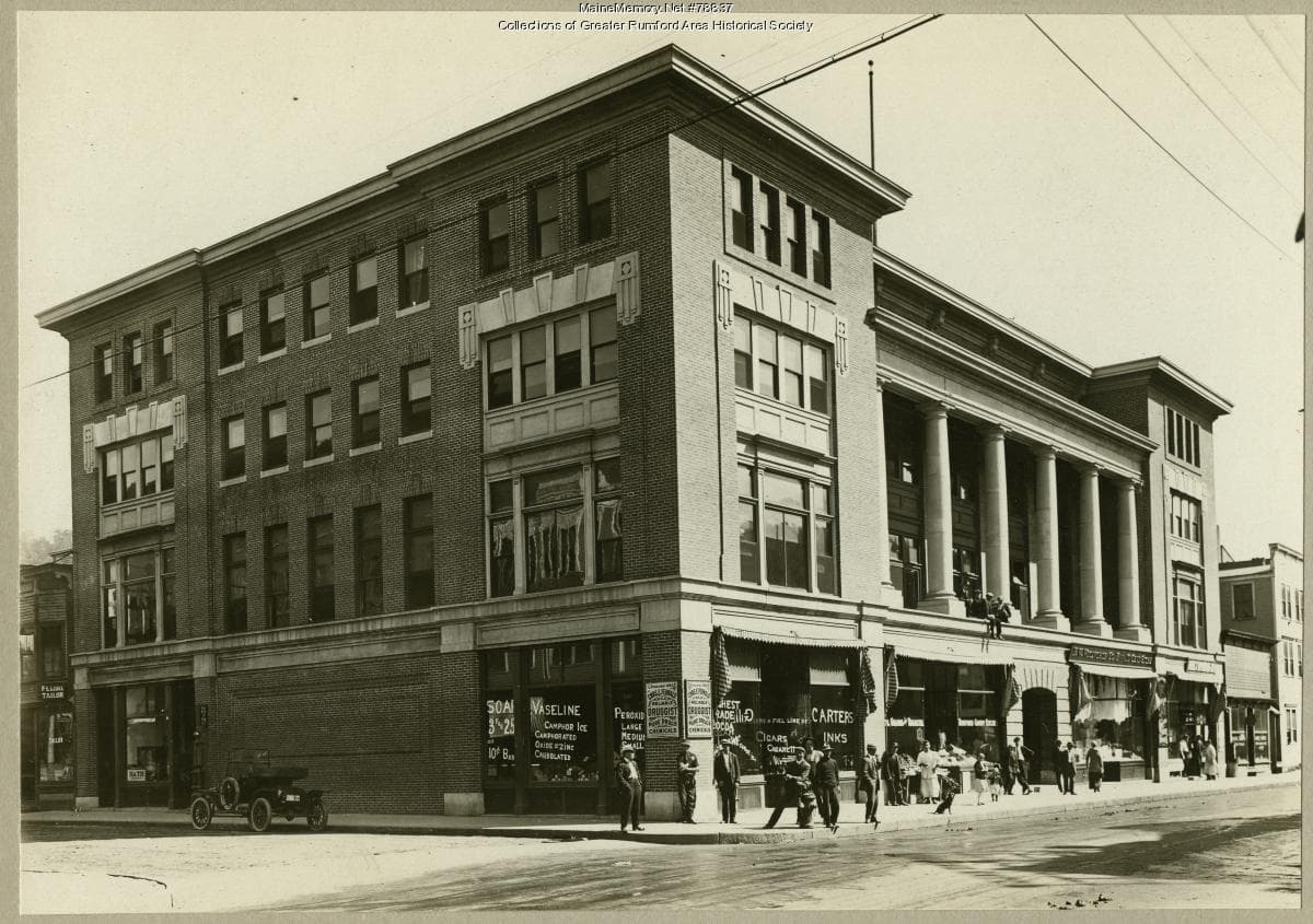 A large four-story brick institutional building with a symmetrical facade, seen from the street.